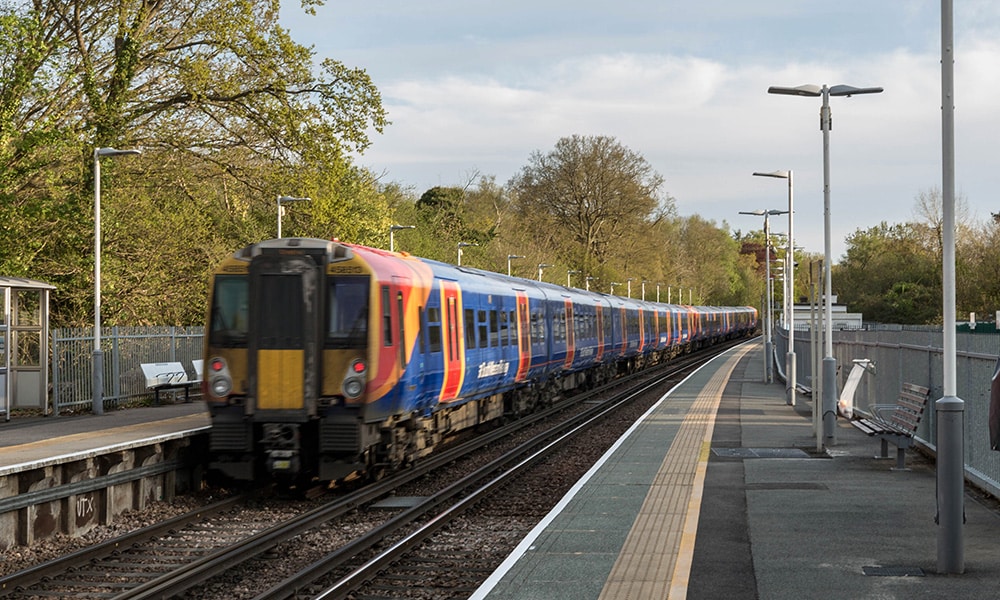 Train to Waterloo passing through a Surrey station