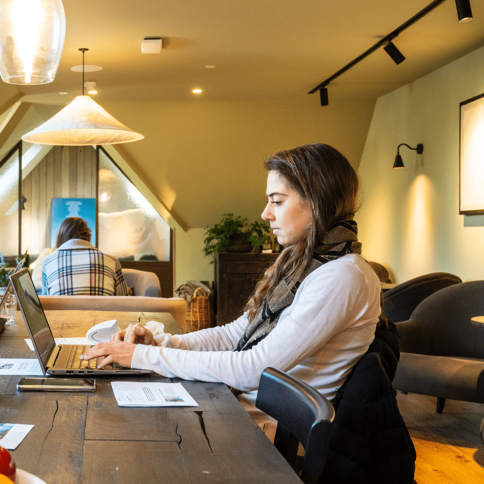 Young woman working on her laptop in the Boathouse co-working space